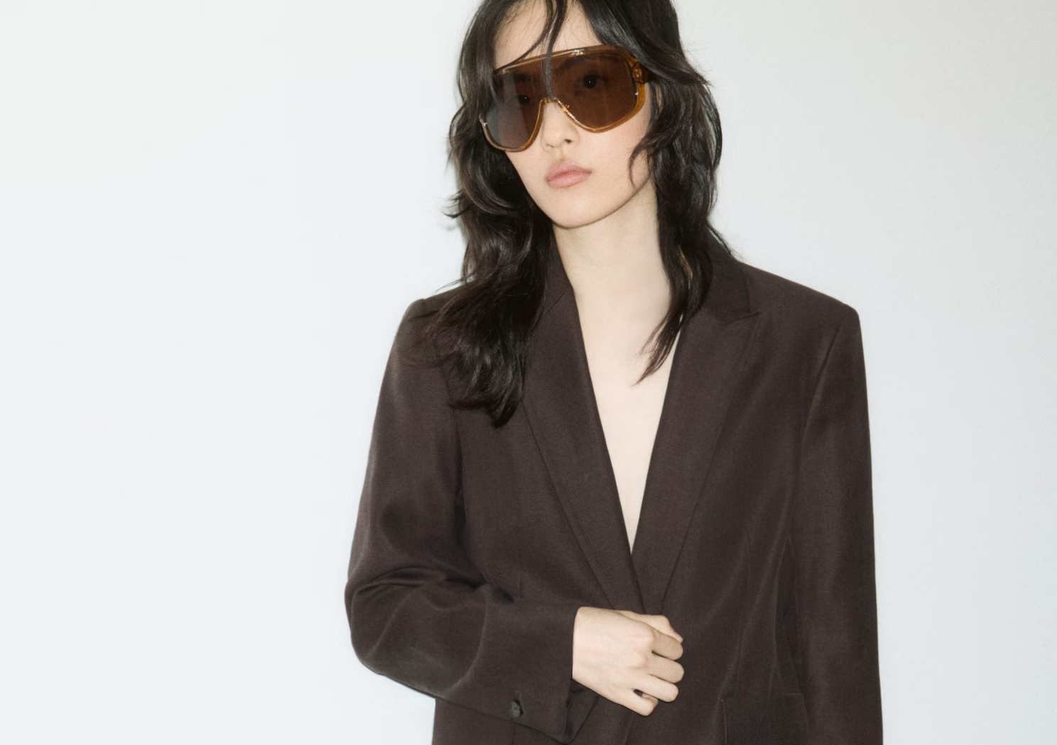 a woman wearing a brown suit
